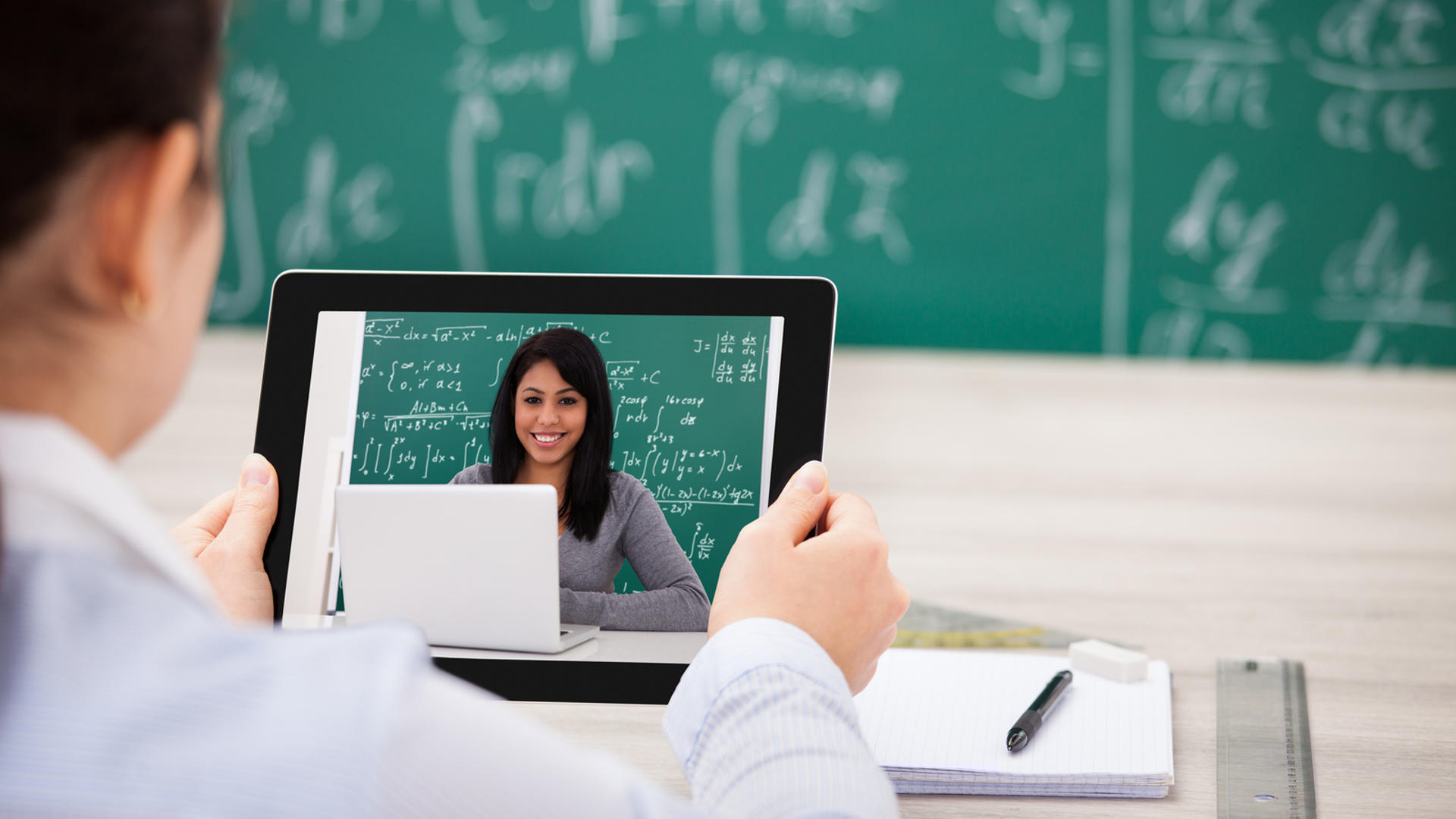 Close-up Of Woman Having Video Chat On Digital Tablet In Classroom